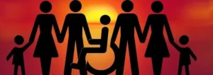 Silhouette of diverse family with wheelchair user at sunset, representing inclusion, support and community